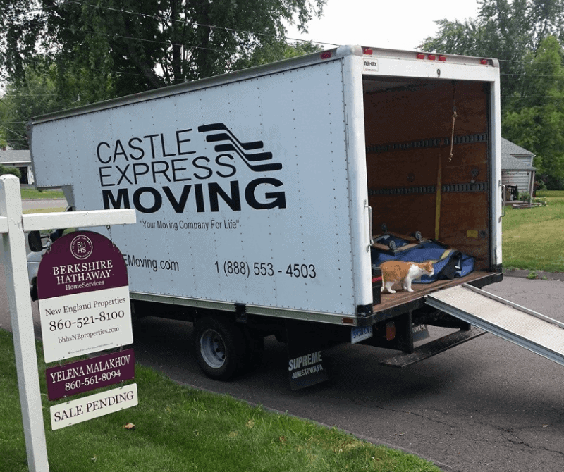 castle express moving truck outside ready to moved items.
