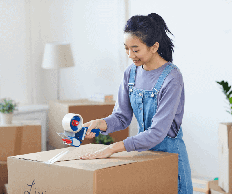 a girl preparing items for moving out